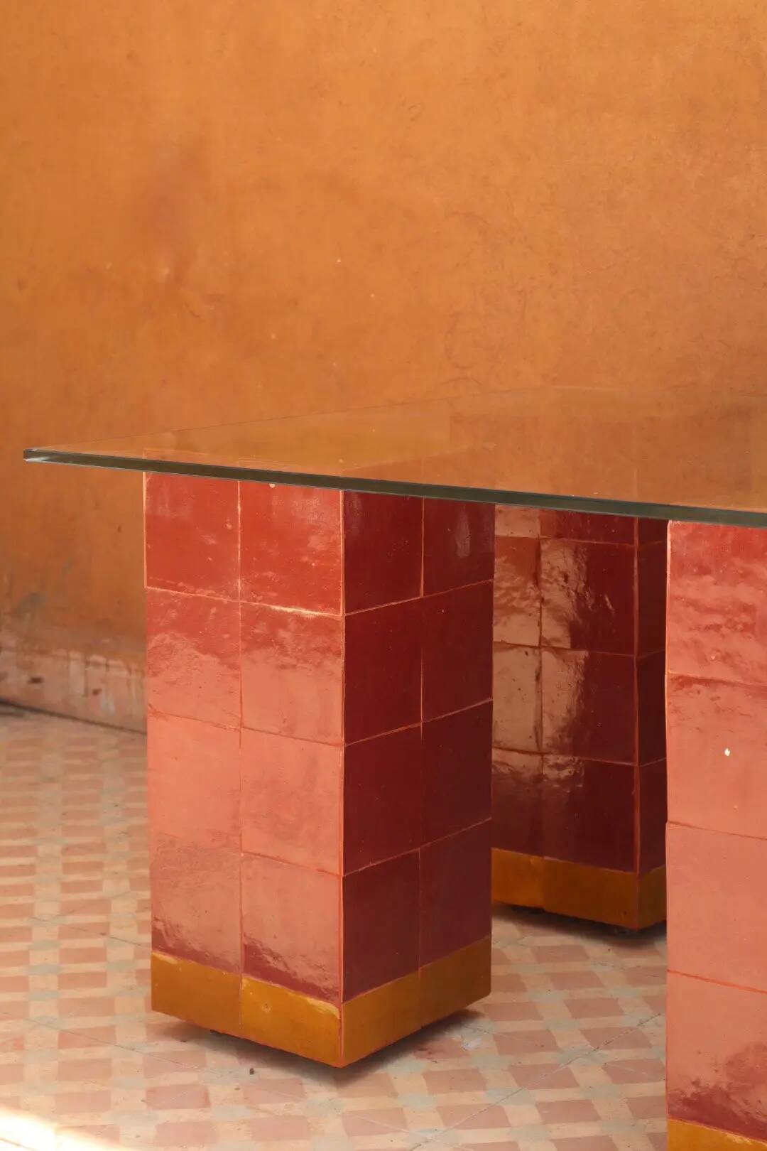 Modern coffee table in burgundy zellige with a tempered glass top.