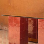Modern coffee table in burgundy zellige with a tempered glass top.