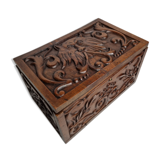 Old carved wooden box decorated with mascaron decoration