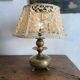 Antique brass lamp with embroidered openwork shade.