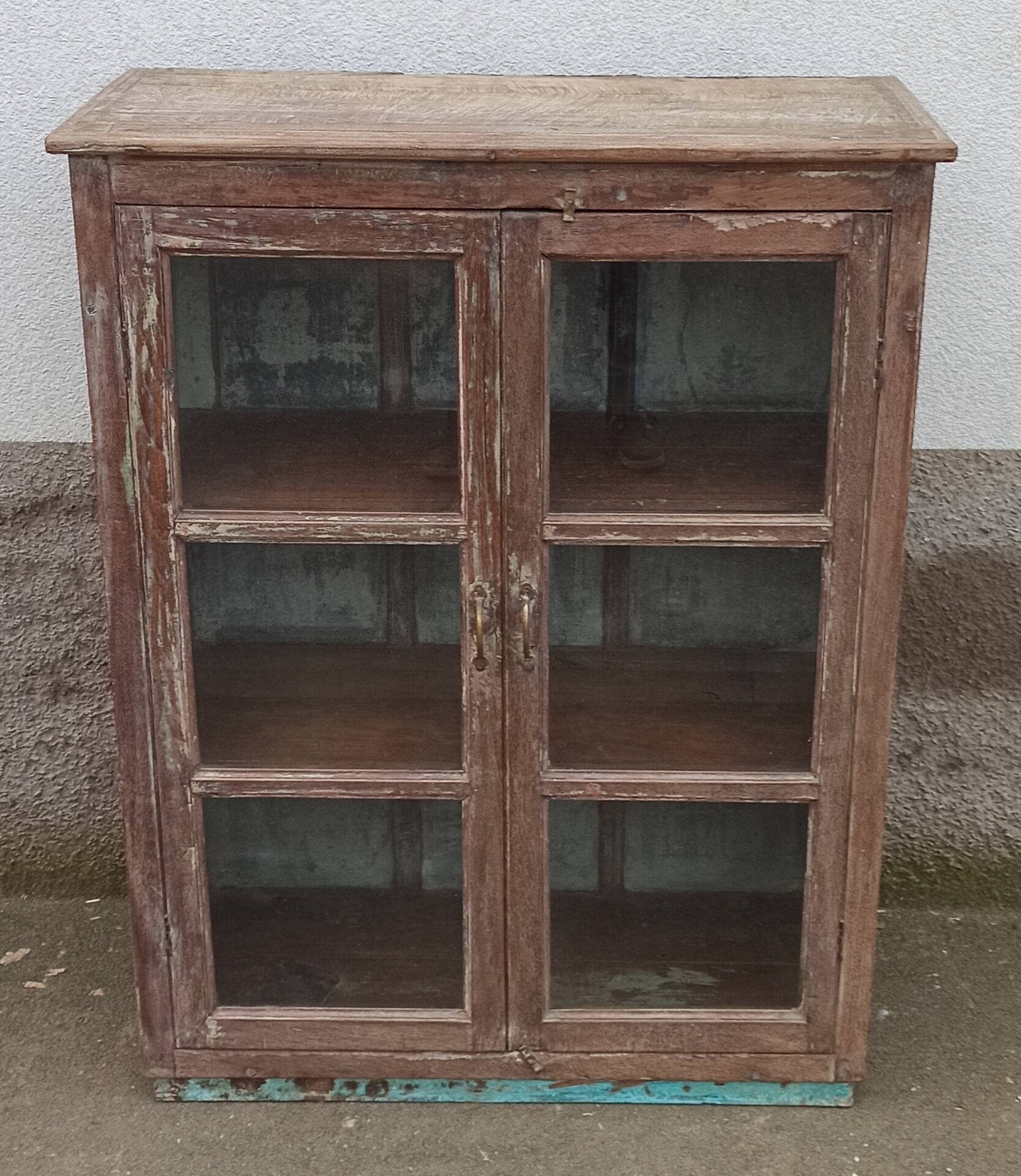Old glazed wooden cabinet with metal bottom