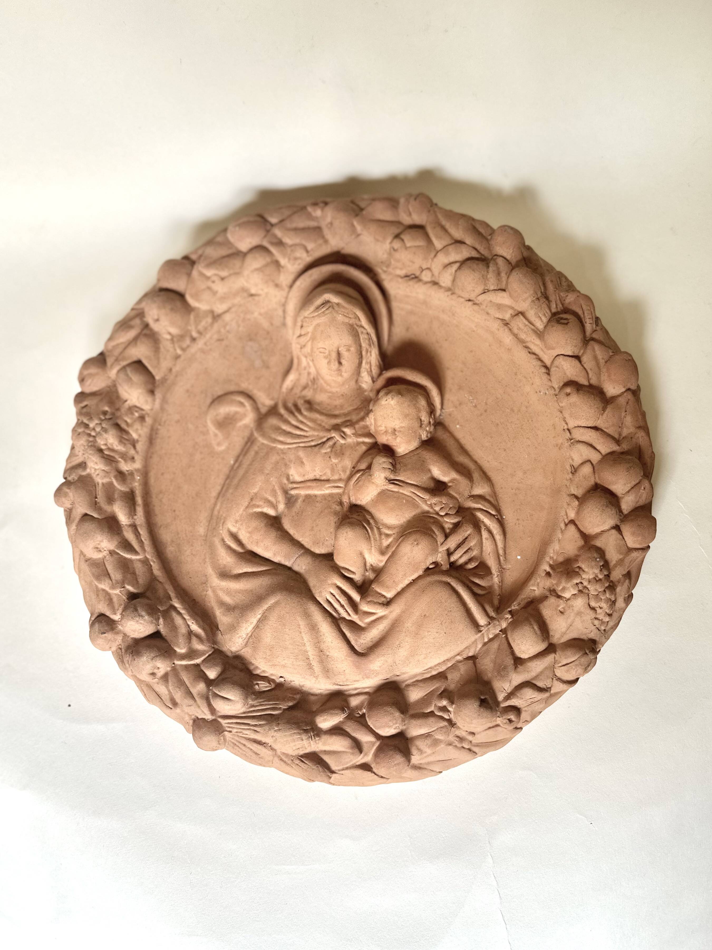 Wall medallion of the Virgin and Child in terracotta