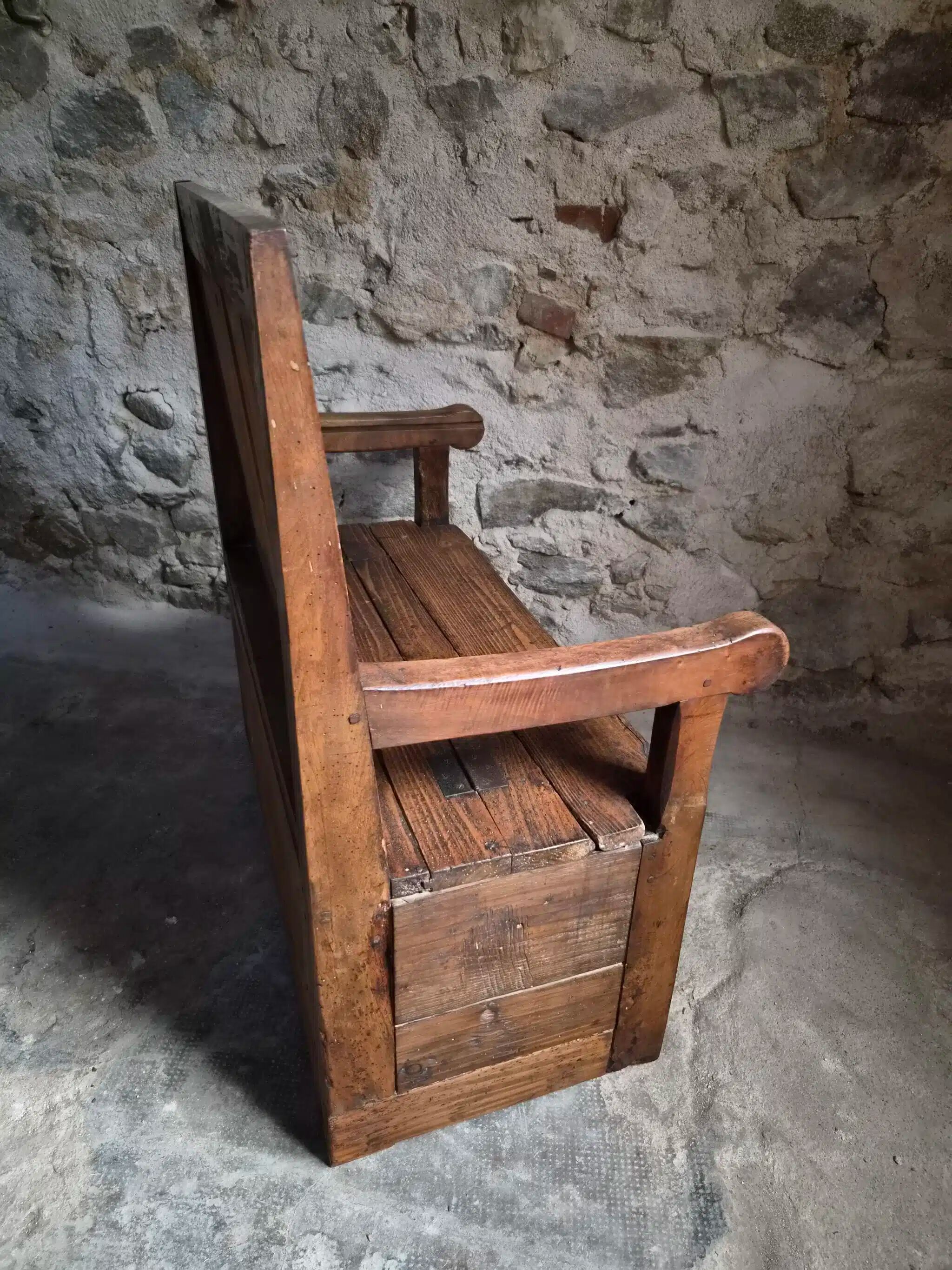 Rustic French antique storage bench from the 18th century in walnut and pine.