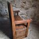 Rustic French antique storage bench from the 18th century in walnut and pine.