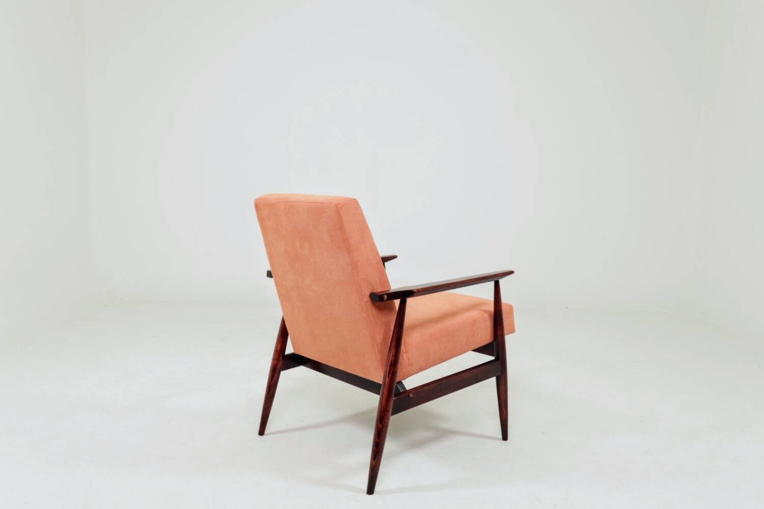 Mid-century modern armchair in coral red designed by H. Lis.