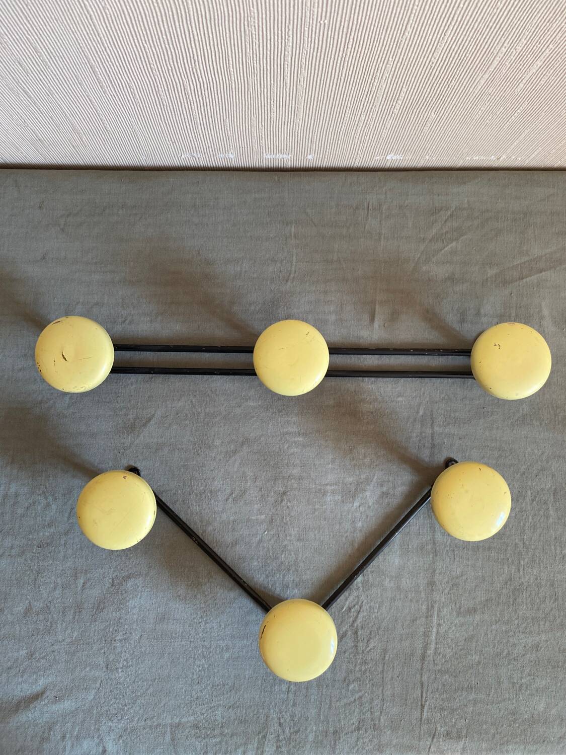2 black and yellow metal wall coat racks