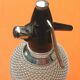 Seltz water siphon Glass body harmoniously meshed with translucent filaments