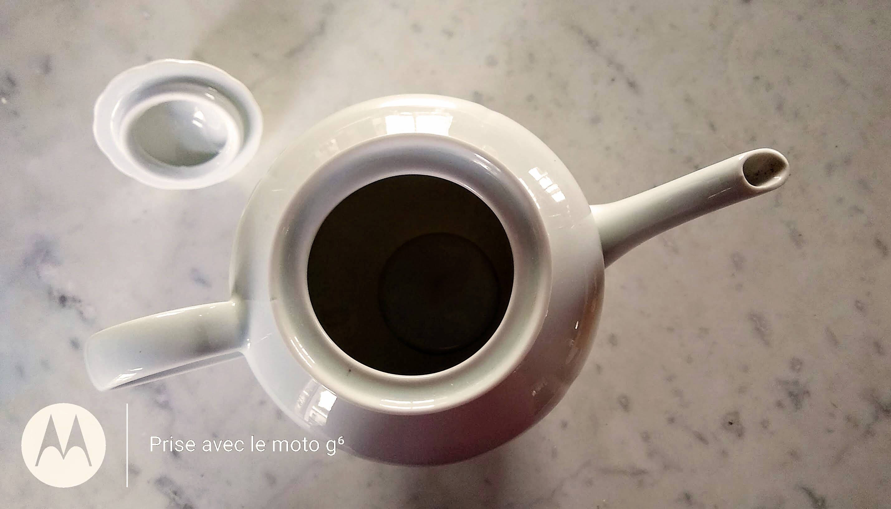 White porcelain teapot with acorn-shaped cap