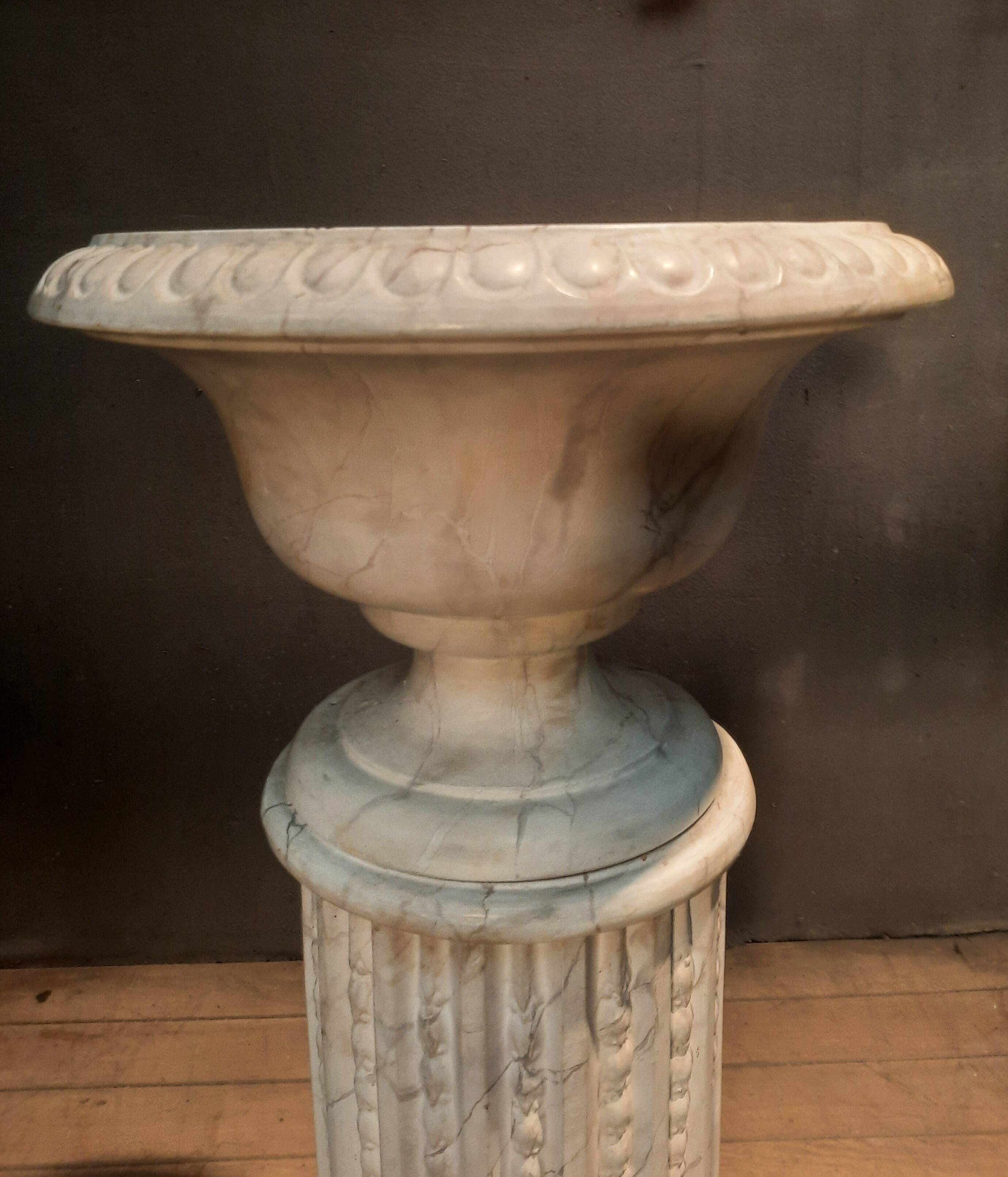 Column topped with a plaster basin.