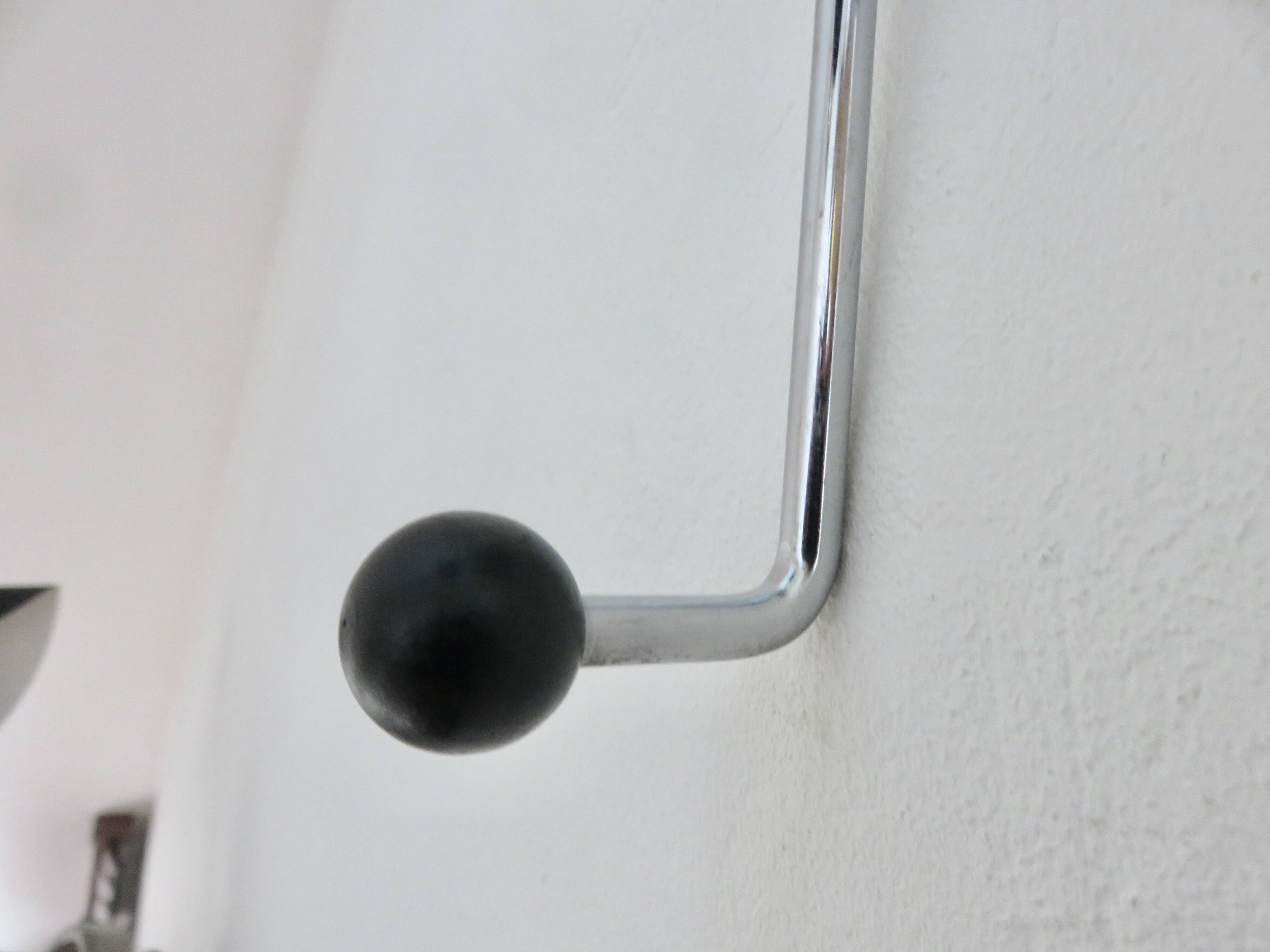 "Streamline" wall coat rack in chromed metal and black lacquered wood, 1970.