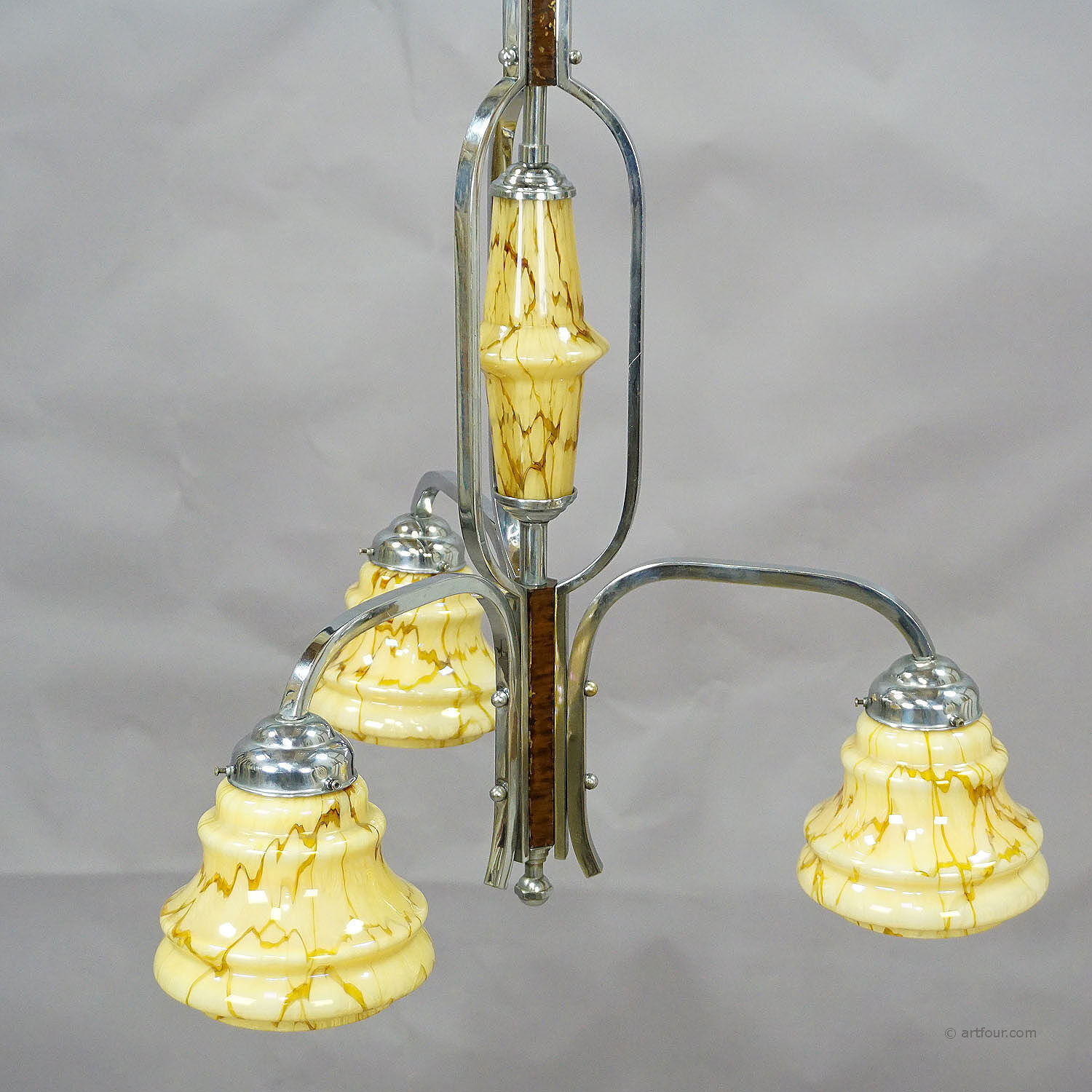 Antique Art Deco chandelier with three glass lampshades.