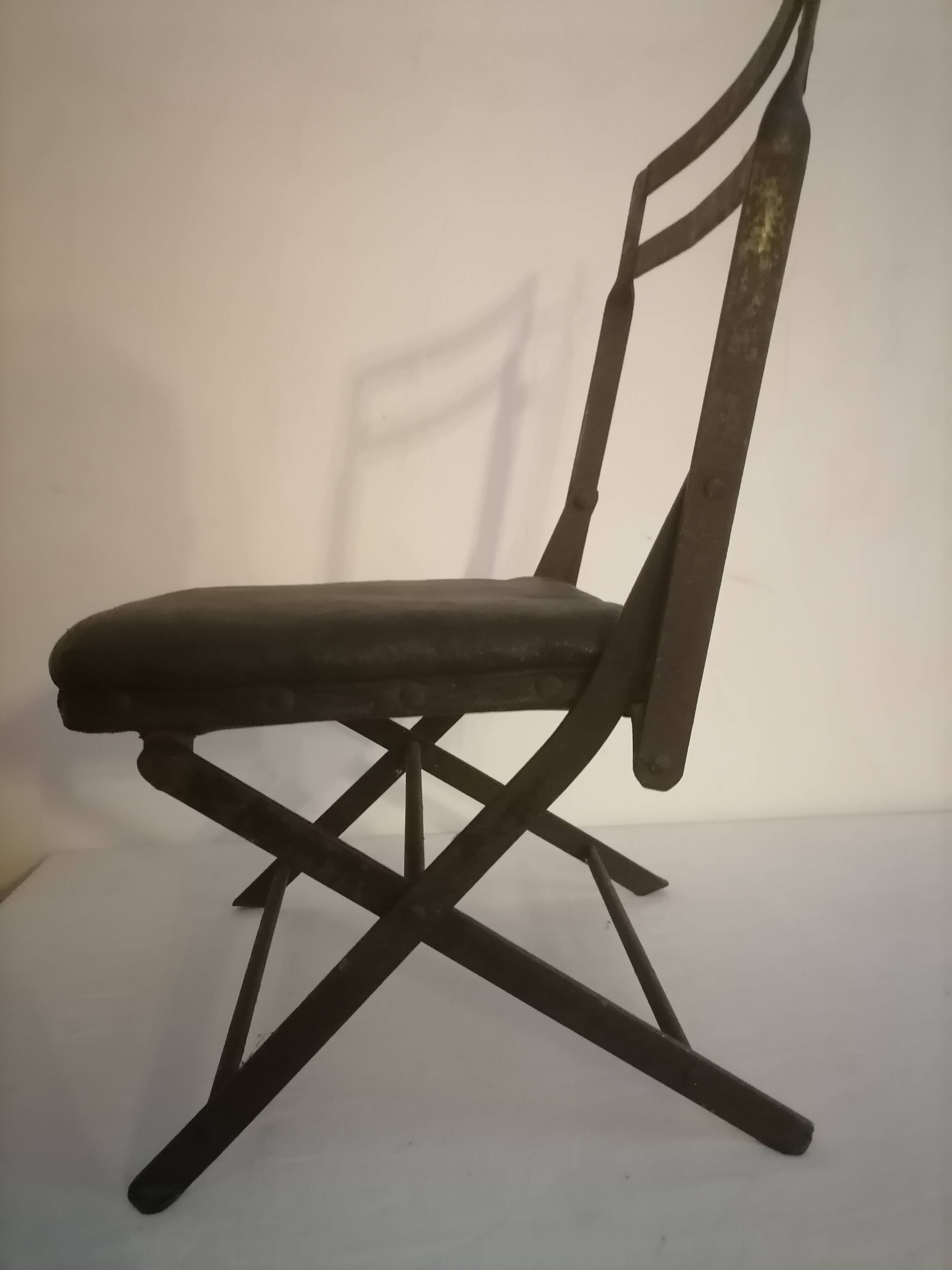 Old wrought iron folding children's chair. Early 20th century.