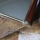 Rectangular mirror tray with wooden handles and gilding.