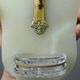 Antique wall-mounted font in green onyx, crucifix in metal and cut glass/crystal.