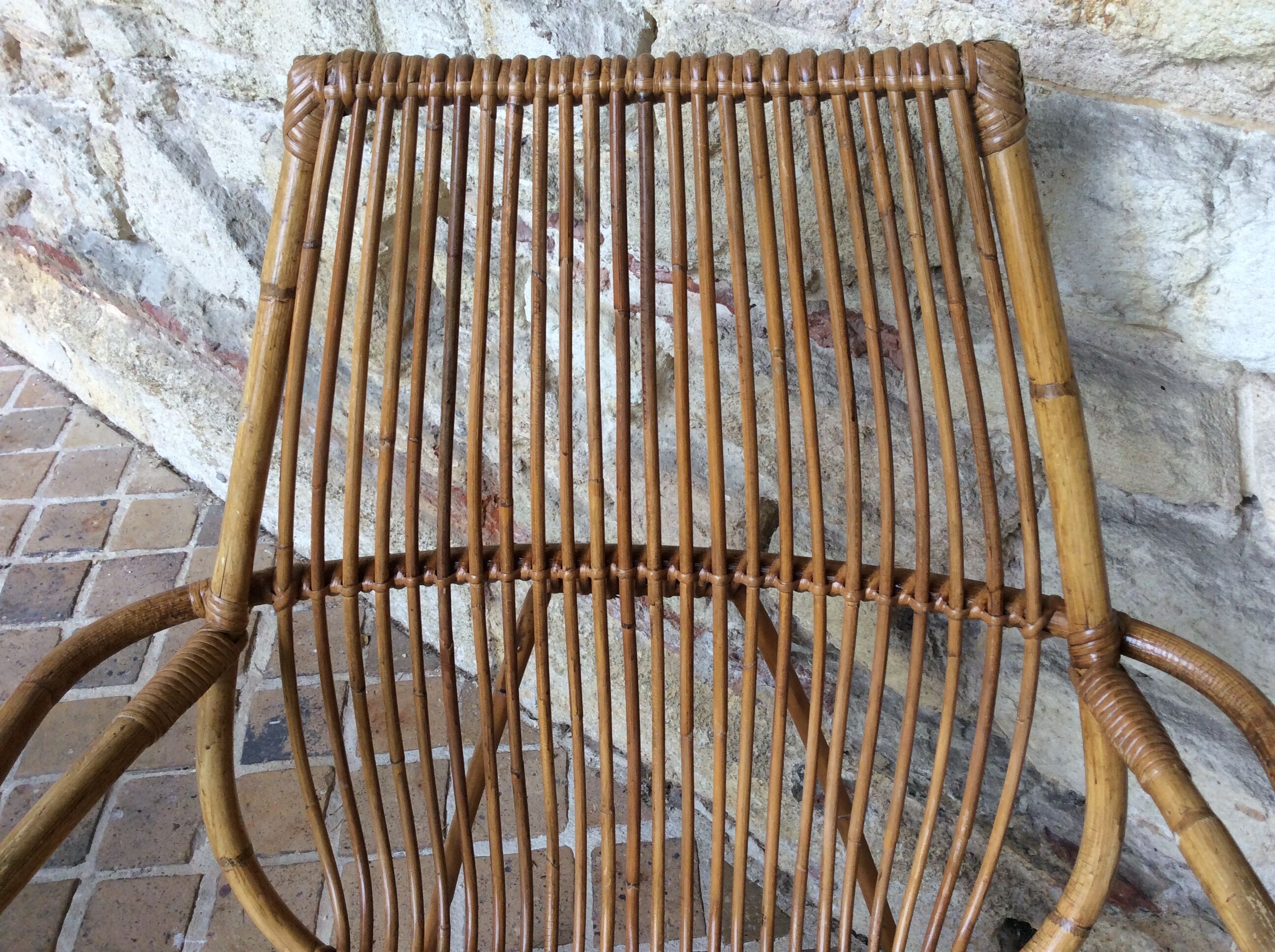 Rattan armchair and his feet rest