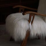 Pair of Scandinavian armchairs in oak and long-haired Icelandic sheepskin by Henning Kjærnulf, 1950.