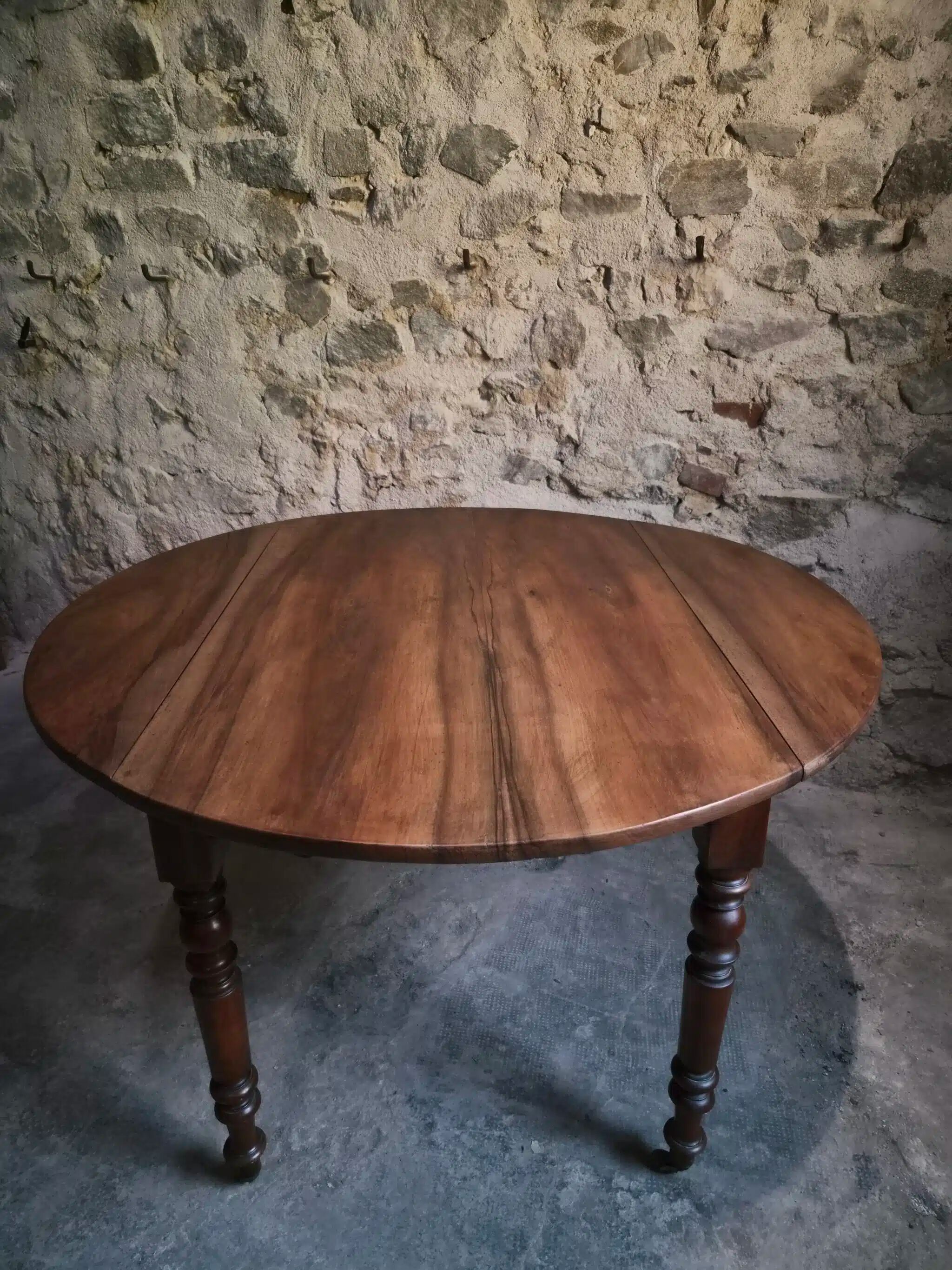 Antique drop-leaf dining table in walnut, France, circa 1900.