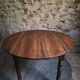 Antique drop-leaf dining table in walnut, France, circa 1900.