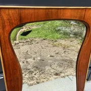 Mid-century organic shaped bevelled mirror in wooden frame, 1940s-50s