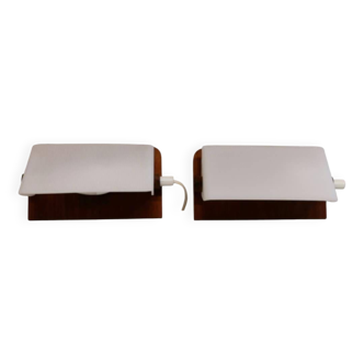 A pair of teak wood wall lamps with plastic shade.