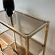 Brass and smoked glass library shelves
