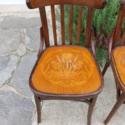 4 bentwood bistro chairs with a pattern on the seat