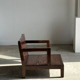 Small low armchair in varnished brown wood