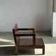 Small low armchair in varnished brown wood