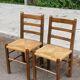 2 solid wood and straw chairs