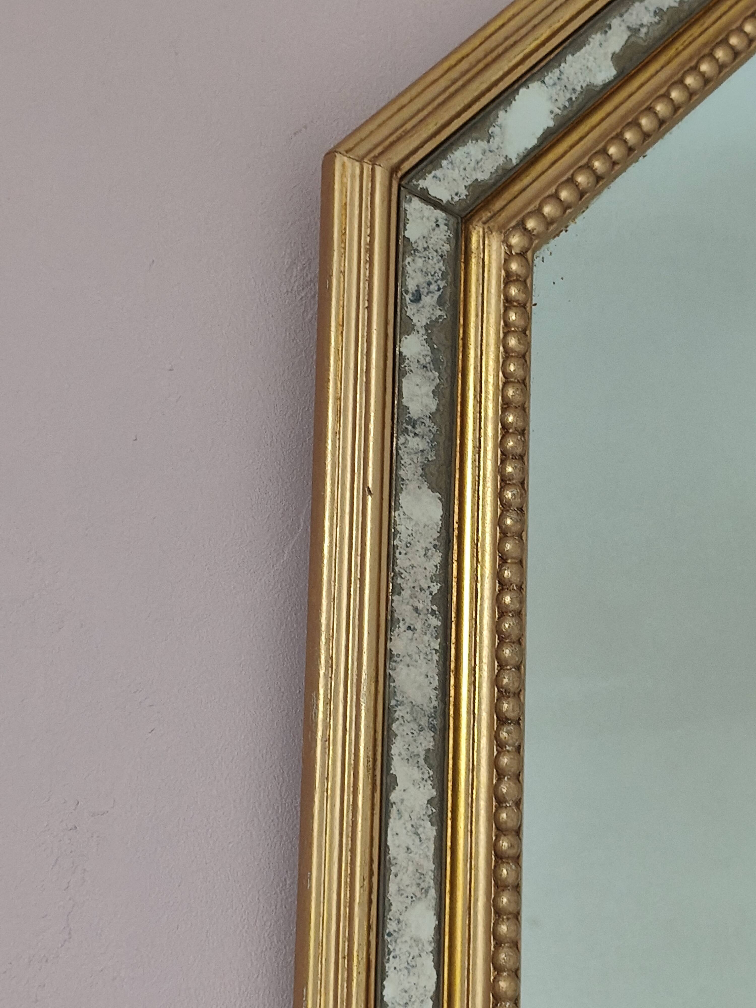 Antique mirror with gilded wooden frame.