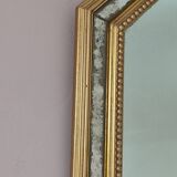 Antique mirror with gilded wooden frame.