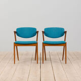 Pair of 42 Kai Kristiansen teak chairs in original blue bouclé upholstery, Denmark, 60s.