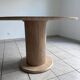 Round table with a travertine effect.