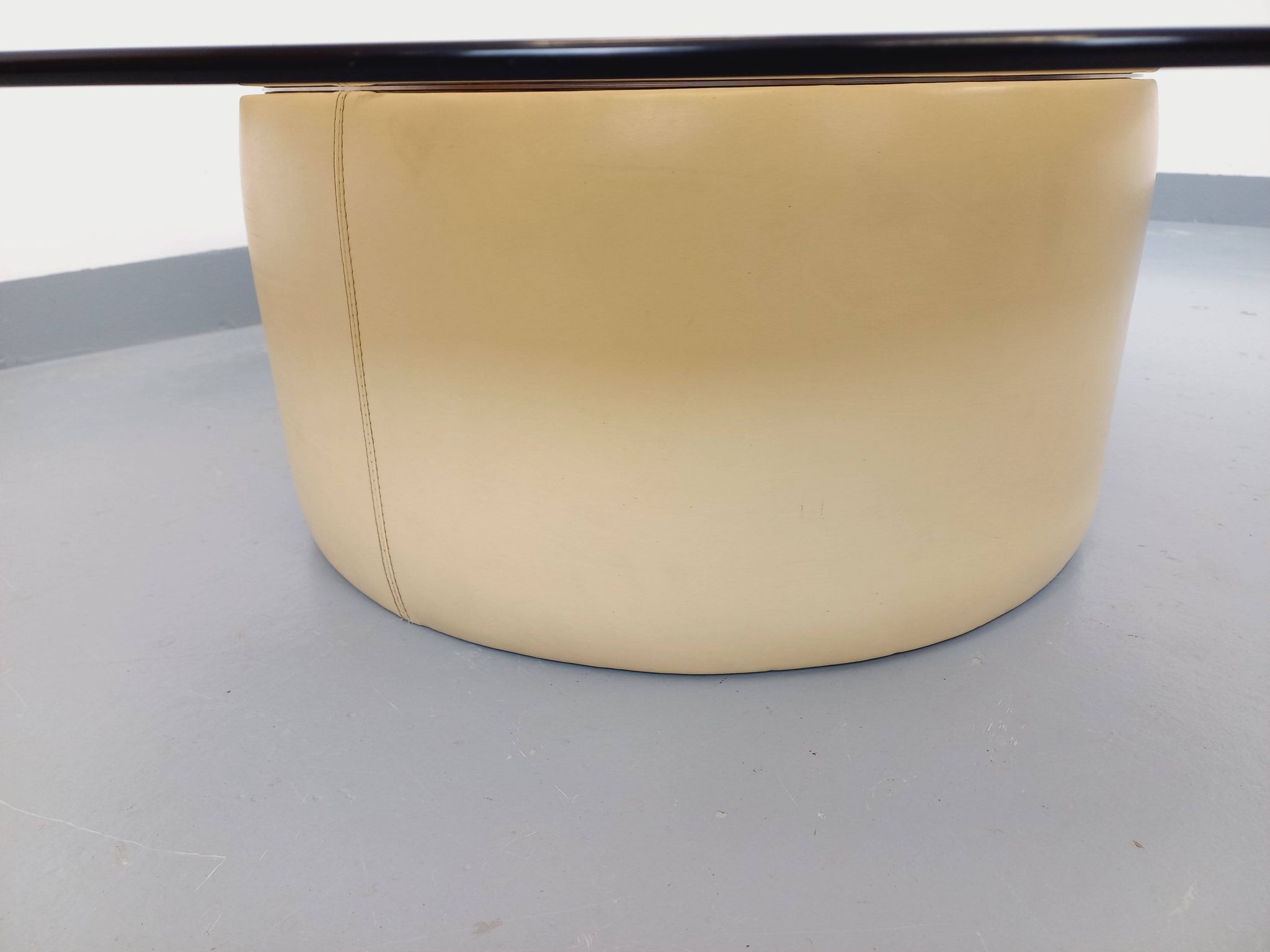 Vintage round coffee table in glass, leather, and metal in Space Age style from the 70s.