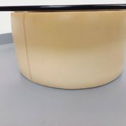 Vintage round coffee table in glass, leather, and metal in Space Age style from the 70s.