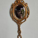 Antique hand-facing mirror in bronze and beveled glass