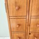 Small wooden piece of furniture, cabinet style, false drawers.