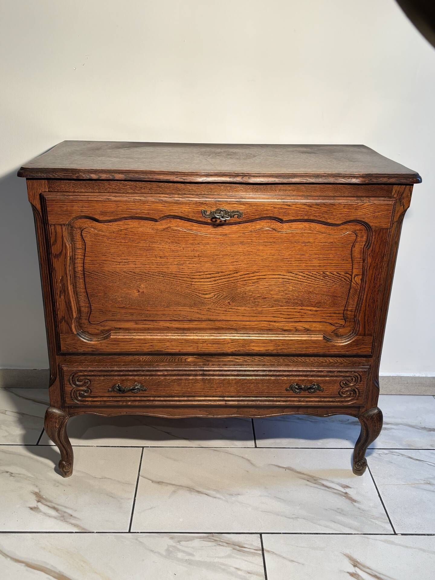 Louis XV style oak TV cabinet with drop-down flap.