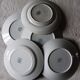 A set of 5 mismatched green blue Terre de fer flat plates