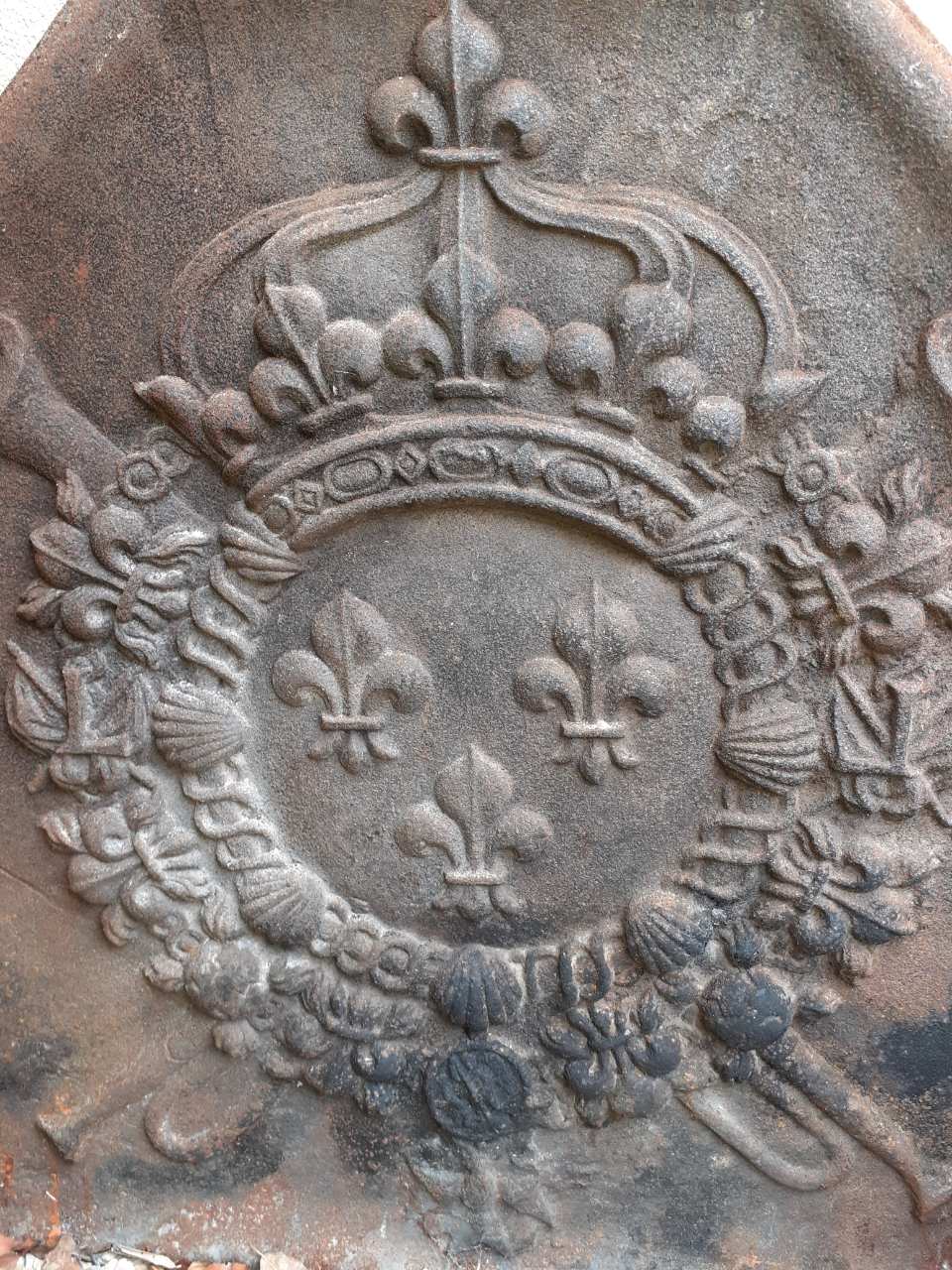 Old cast iron fireplace plate with lily flowers