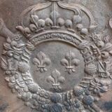 Old cast iron fireplace plate with lily flowers