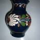 Blue glazed earth pitcher and flowers