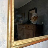 Antique gilded mirror with pearl and gold leaf.