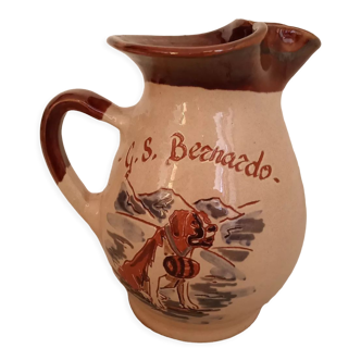 GS Bernardo enameled pitcher decorated with a dog in nature, stamped Arta