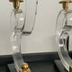 Pair of Hollywood Regency candlesticks in lucite and brass