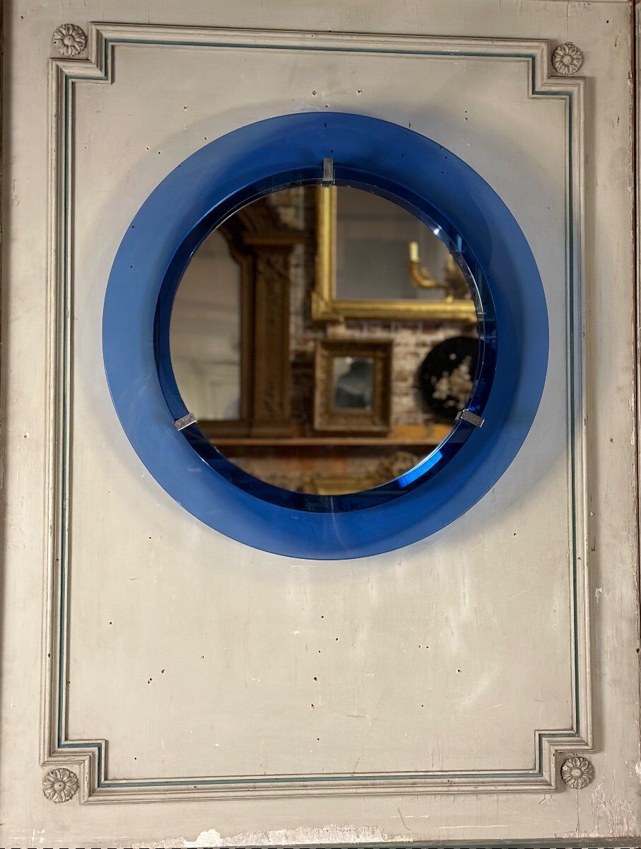 Mirror framed by a blue glass circle, italy circa 1950