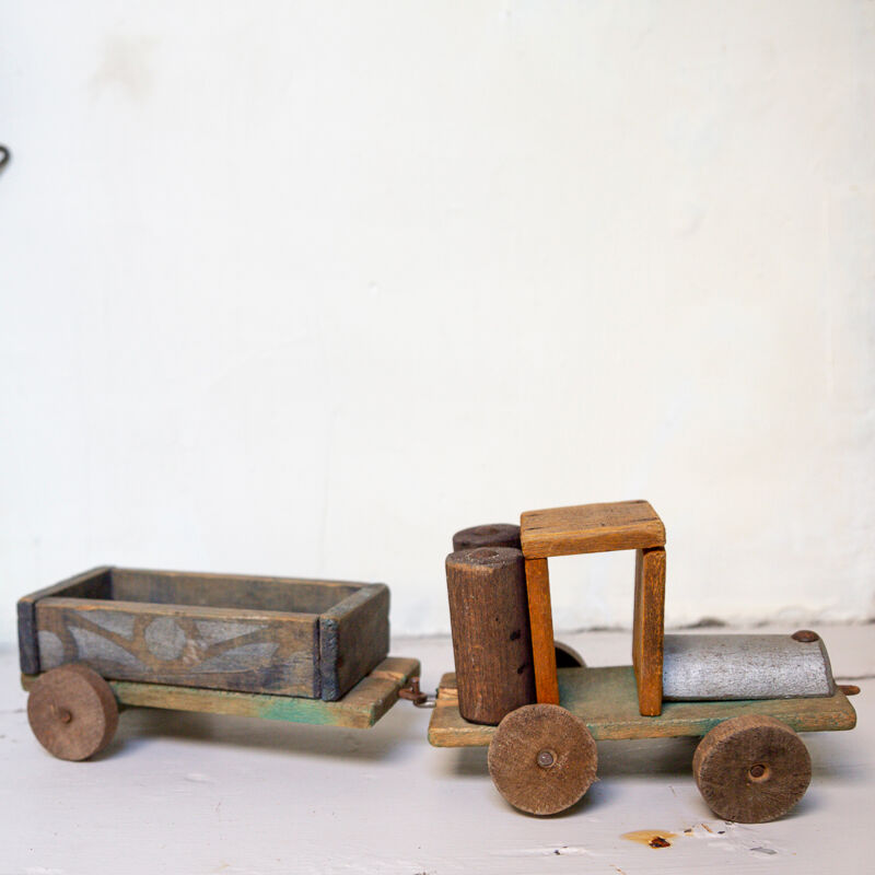 Old wooden train locomotive and toy trailer