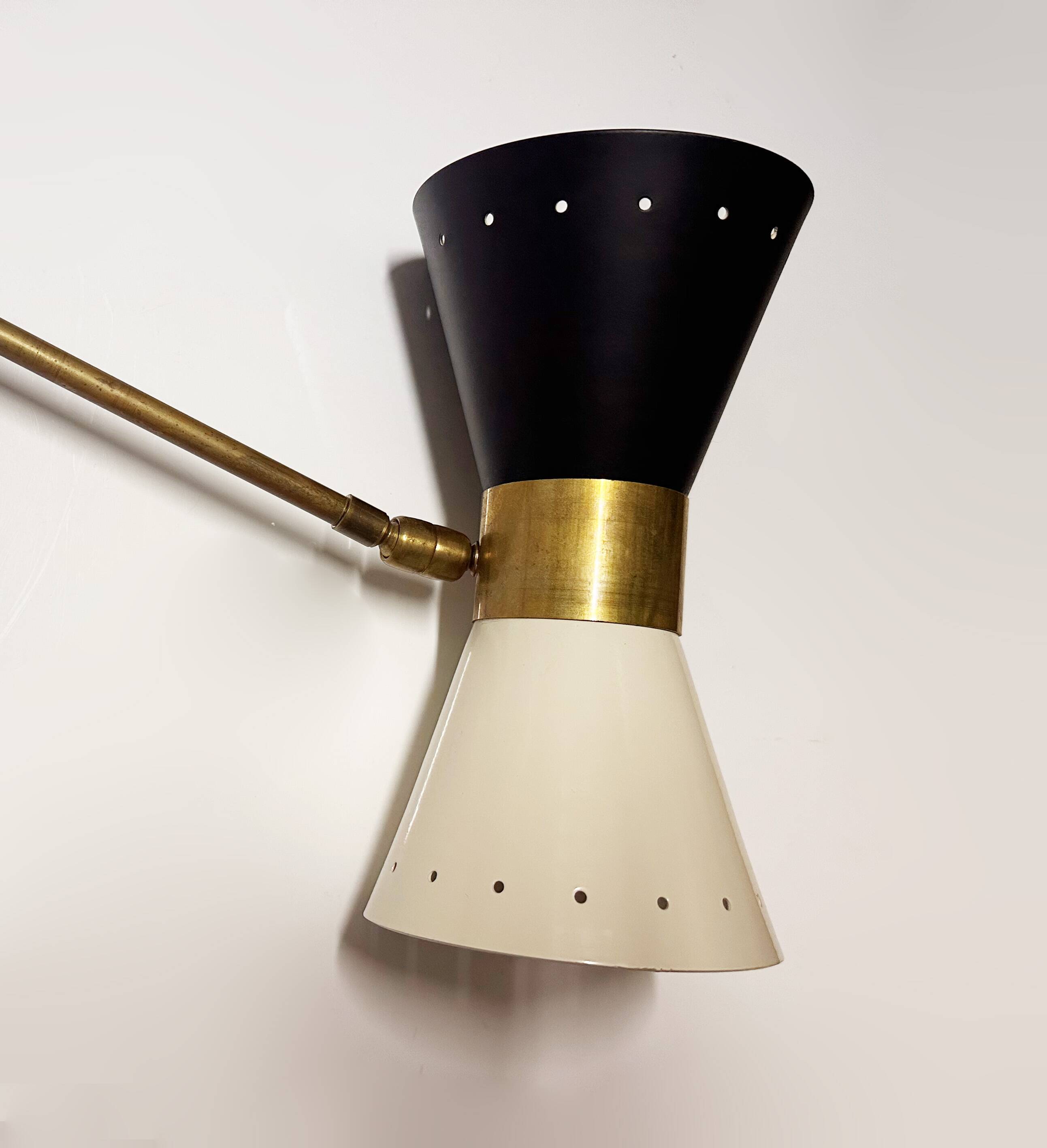 Articulated brass and lacquered iron wall light, 1950s design.