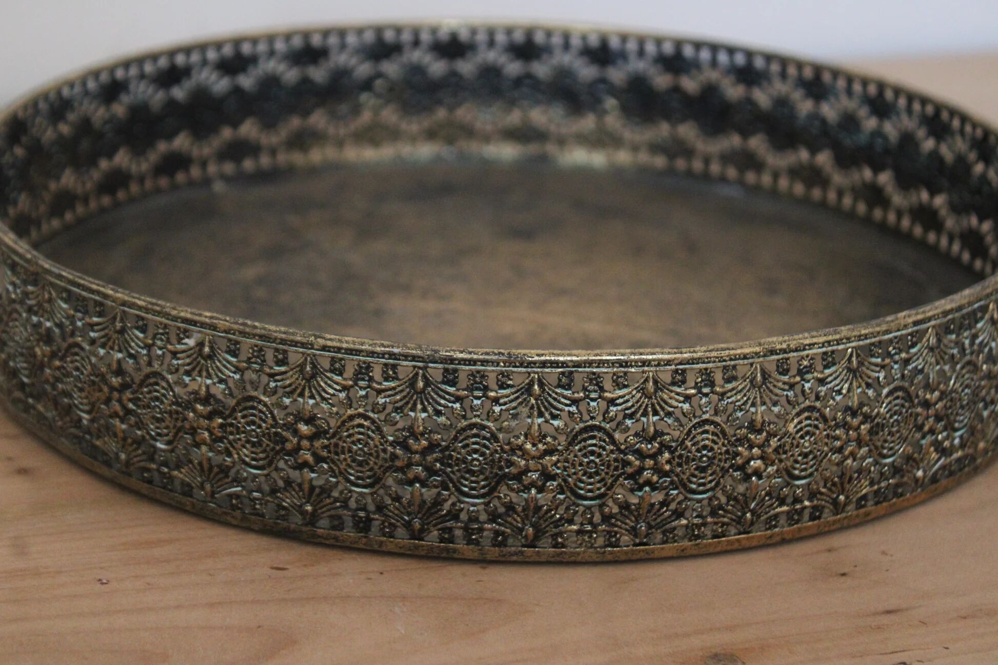 Round metal plate in patinated gold with an openwork border – D30 cm