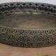 Round metal plate in patinated gold with an openwork border – D30 cm